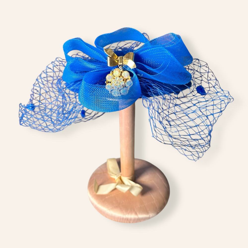 Blue fascinator with accent brooch on horse hair bow